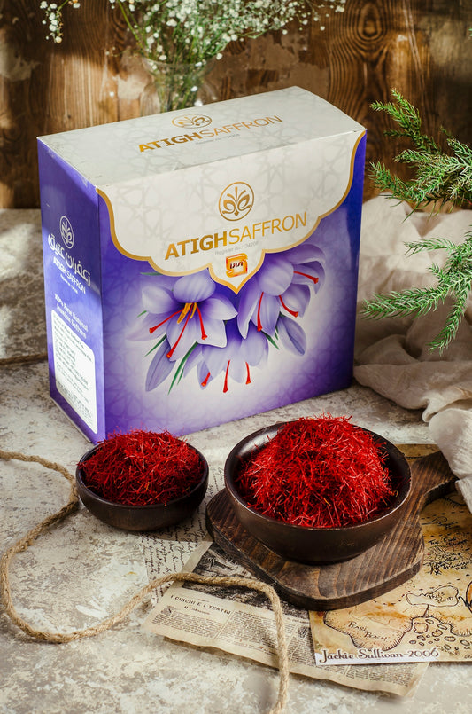a box of saffron next to two bowls of saffron