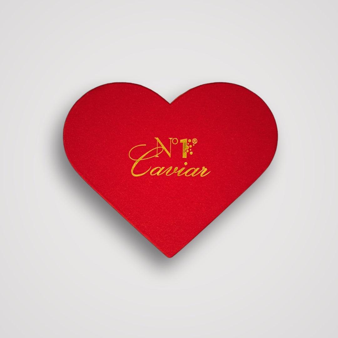 Red heart-shaped box with 'N.F. Caviar' text on a light gray background
