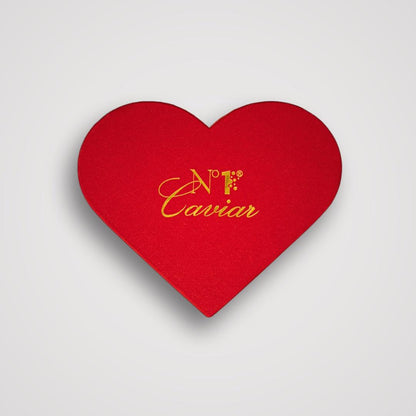 Red heart-shaped box with 'N.F. Caviar' text on a light gray background