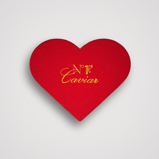 Red heart-shaped box with 'N.F. Caviar' text on a light gray background