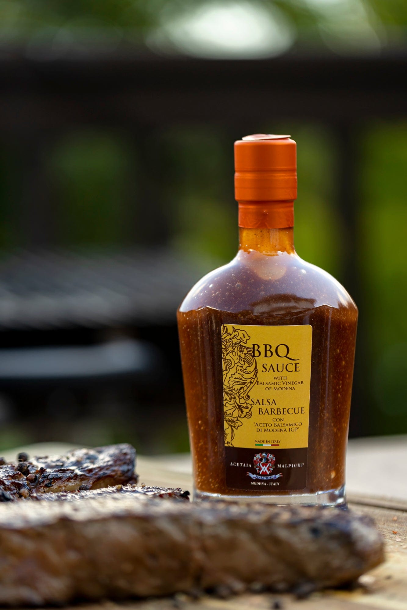 Bottle of BBQ sauce with a blurred outdoor background