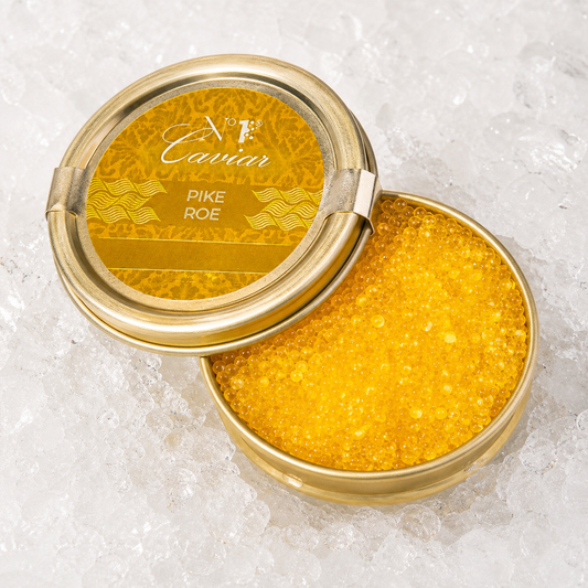 Open container of caviar with a gold lid on a white background