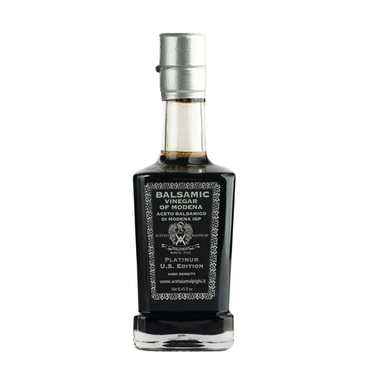 Balsamic vinegar bottle with a black label on a white background