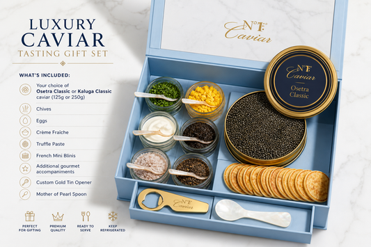 Luxury caviar tasting gift set with caviar, crackers, and accompaniments on a marble surface.
