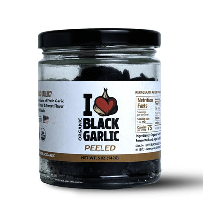 Jar of organic black garlic on a white background