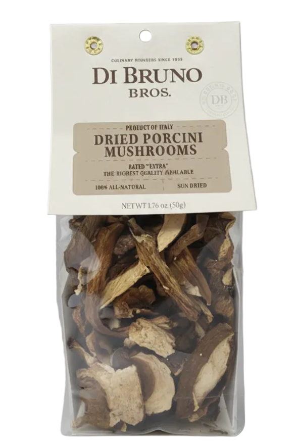 Bag of dried porcini mushrooms with Di Bruno Bros. label on a gray background